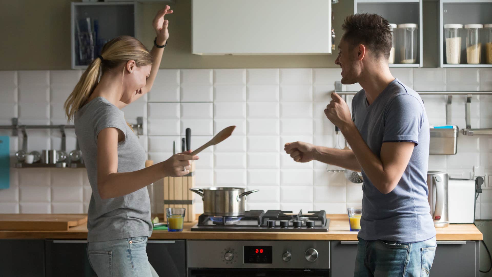 a couple plays music as they cook for their guests