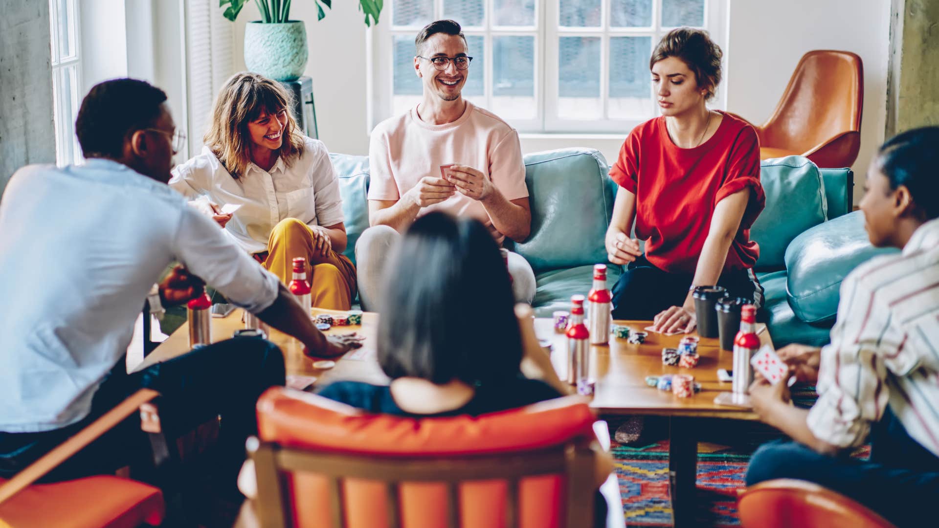 a woman makes sure that guests all have drinks and snacks during a board game hangout