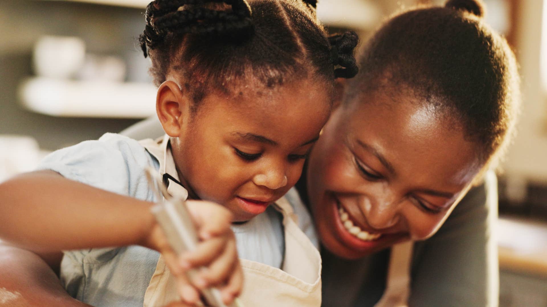 a woman makes a child feel included in the party by helping her cook