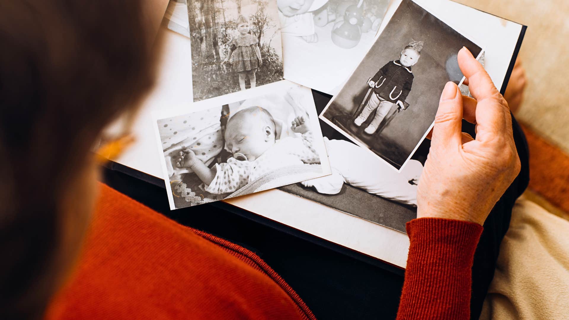 woman looks at meaningful black and white photos she loves