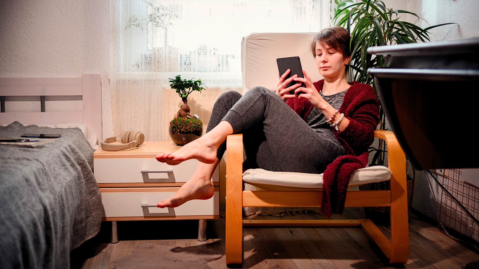 woman rests and reads a book in a safe place in her home