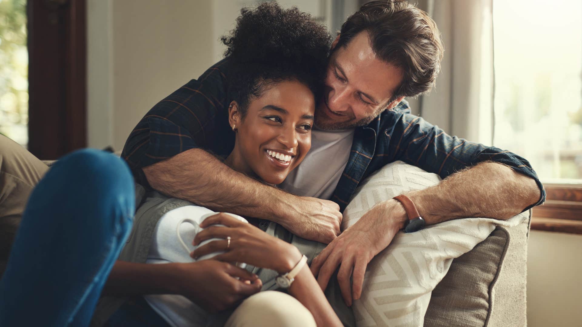 couple cuddling together on the couch