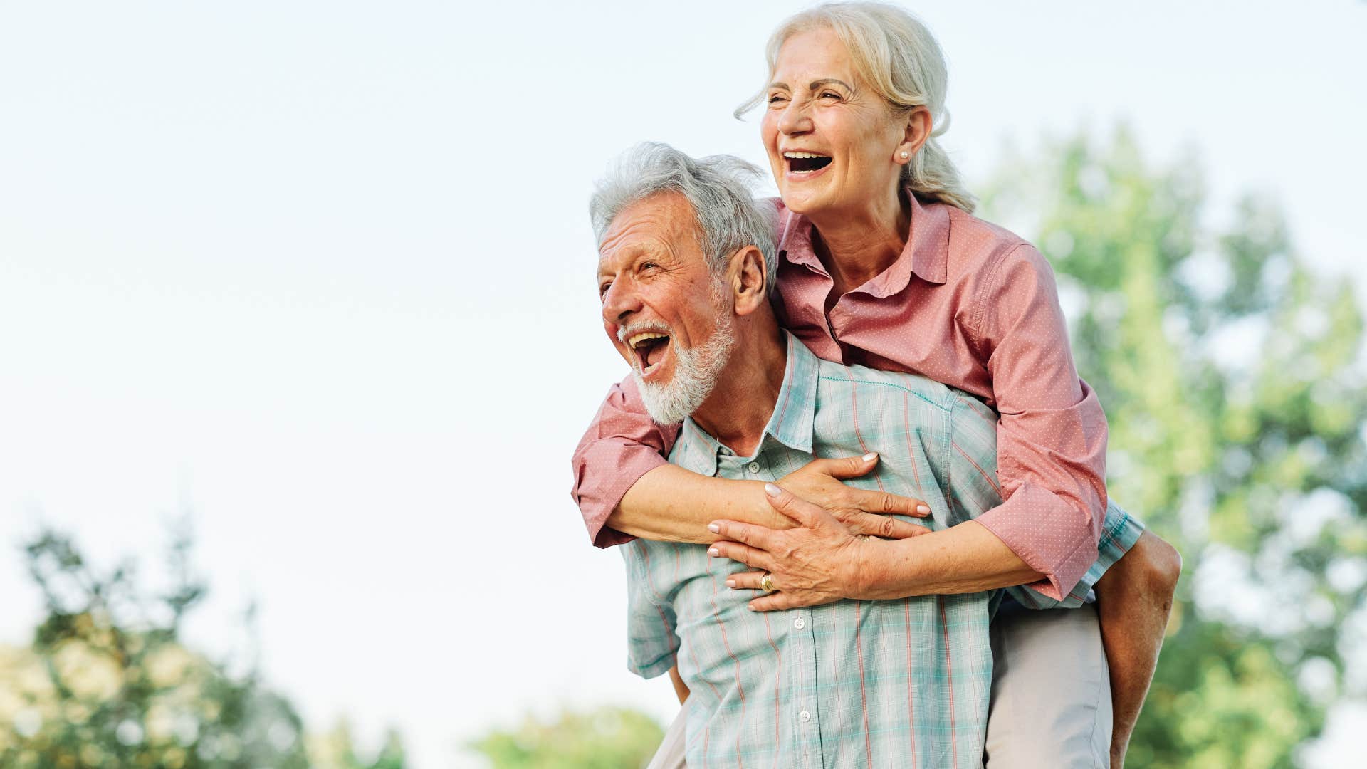 older couple having fun outdoors growing old together