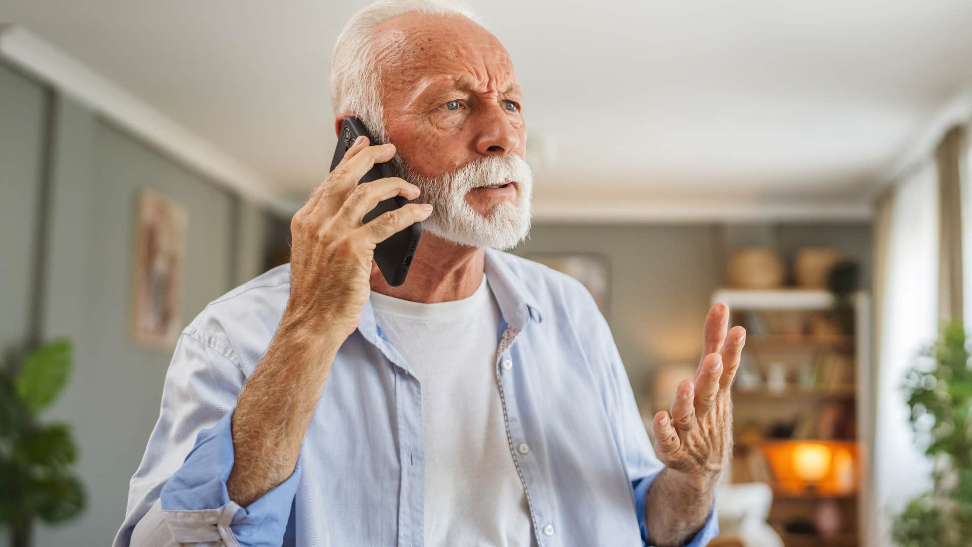 Man asking "Why don't you come over more?" on the phone with his son.