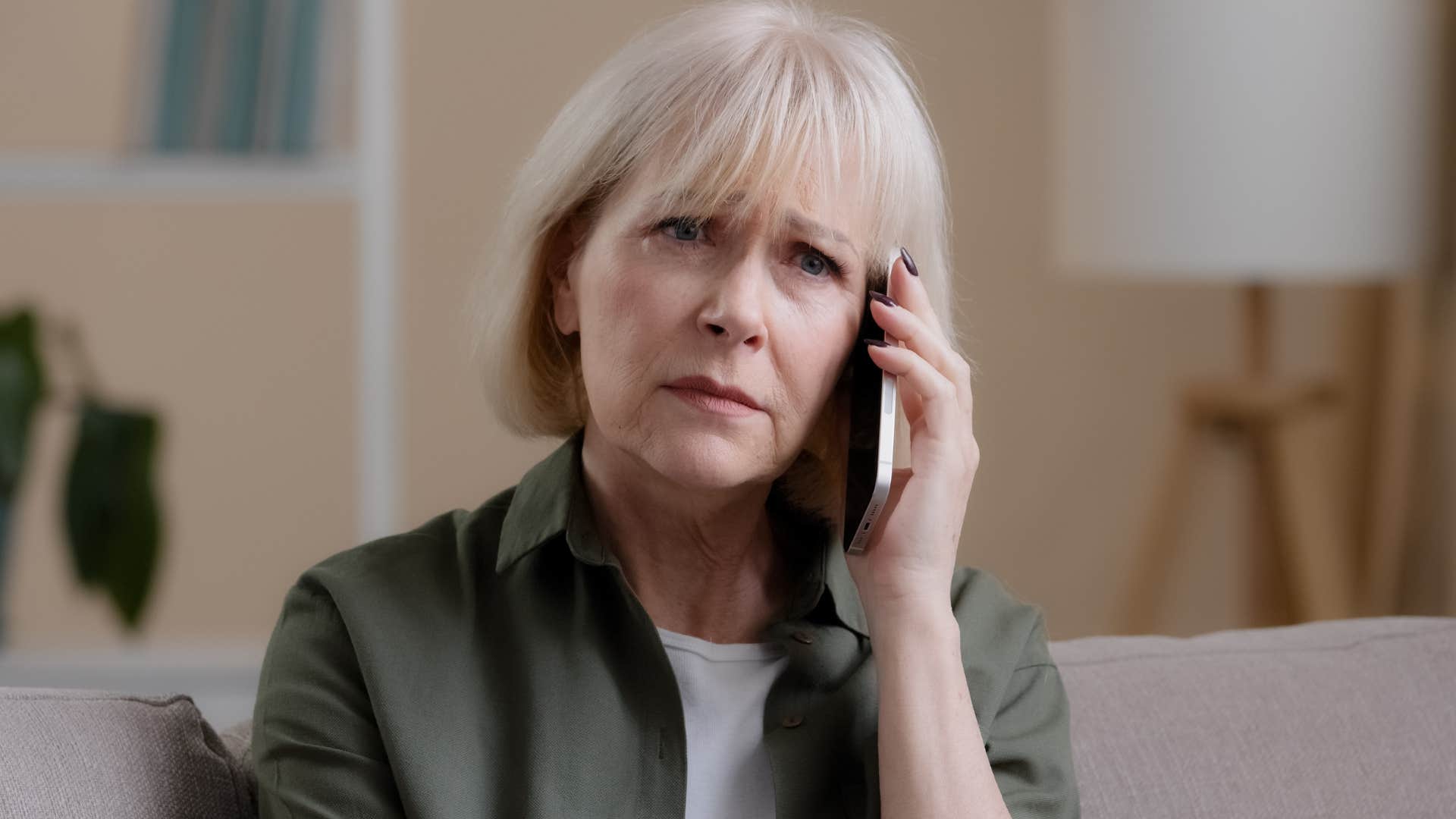 Woman saying "that's how the world works" to her adult son on the phone.