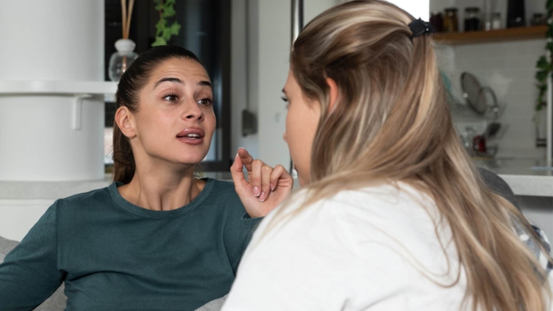 woman telling friend she needs her to stop talking before she embarrasses herself 
