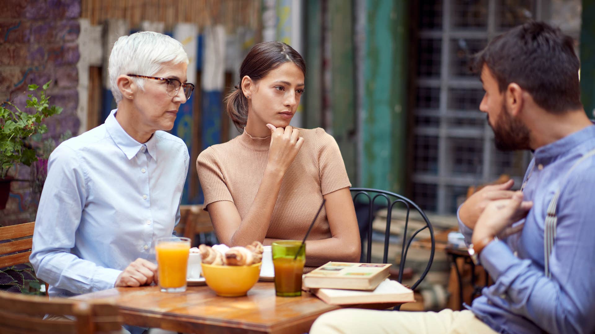 two friends listening to man talk