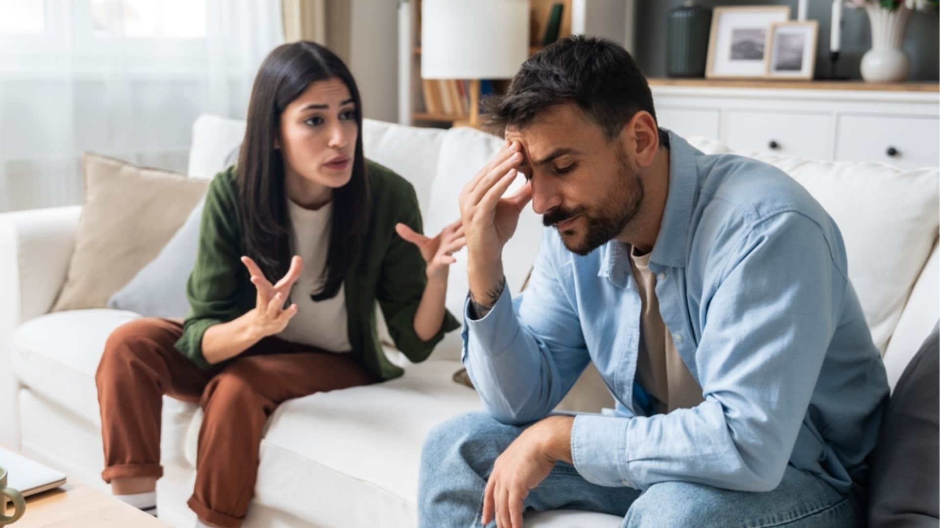 frustrated woman telling her boyfriend that hes holding her back