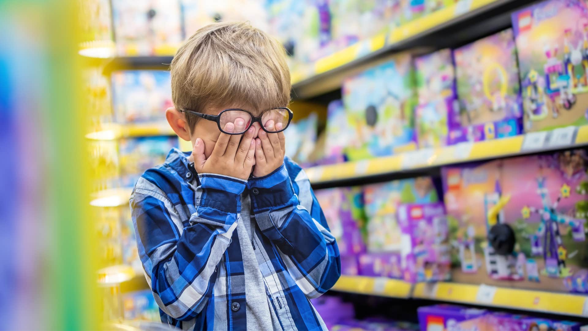 little boy looking upset at toy store