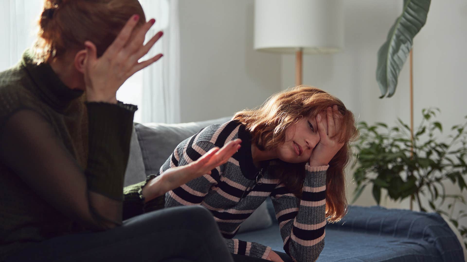 mom in brown sweater screaming because i said so that's why while daughter in stripped shirt looks done