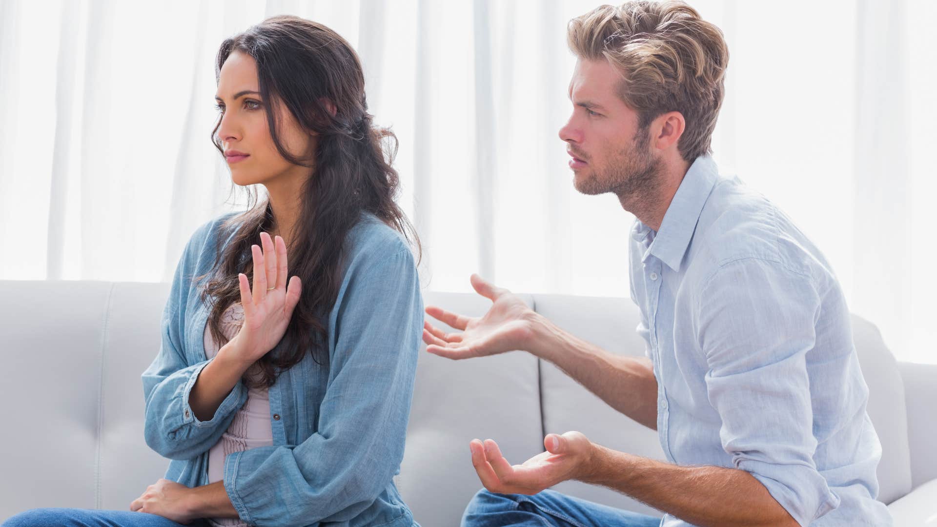 man shrugging during fight with wife saying everything is fine