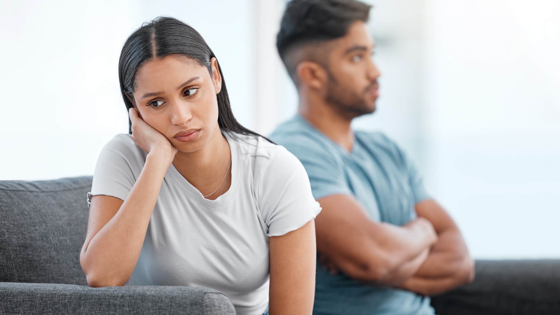 frustrated woman turned away from husband who wont listen