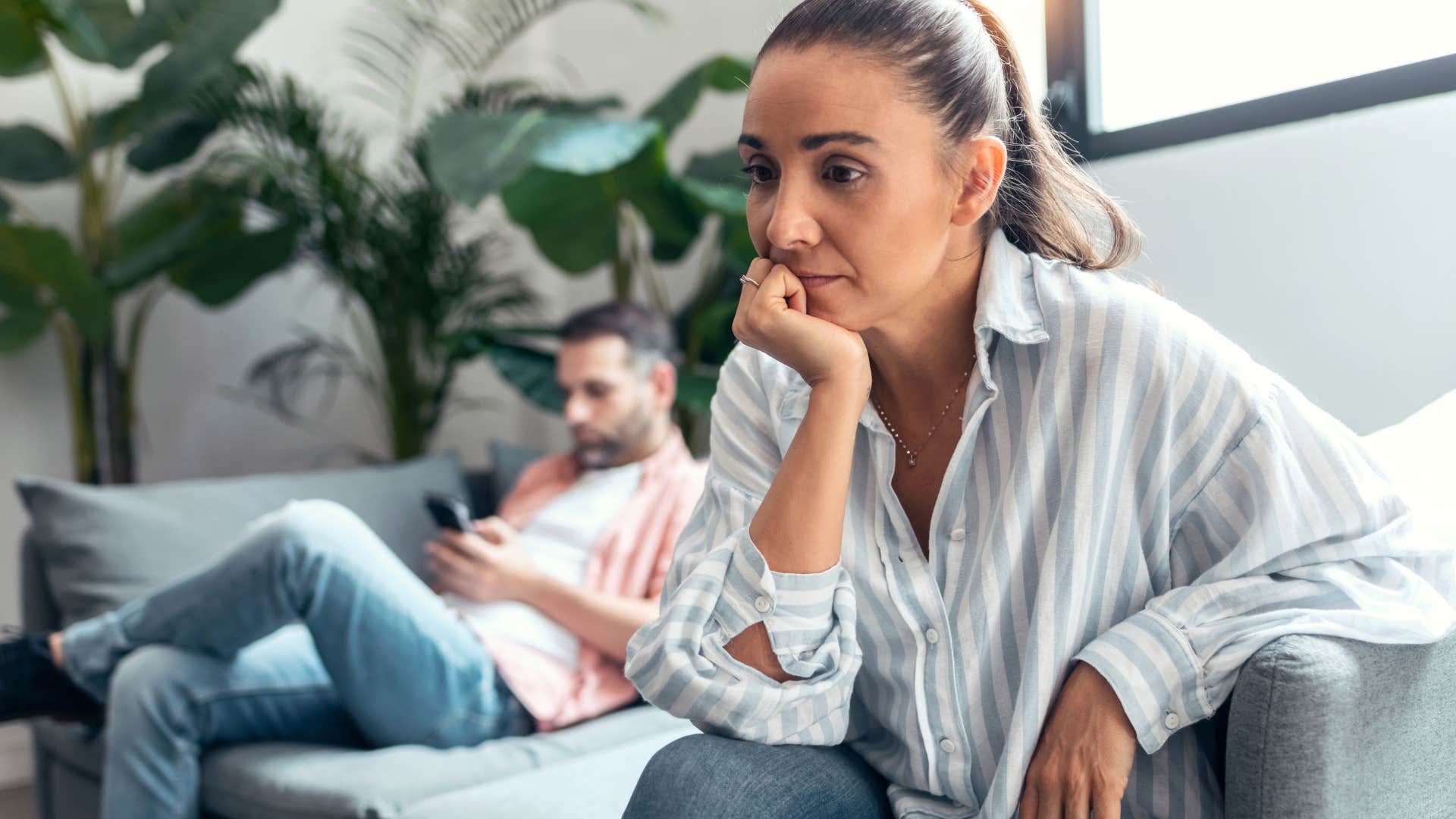 woman turned away from her lazy husband