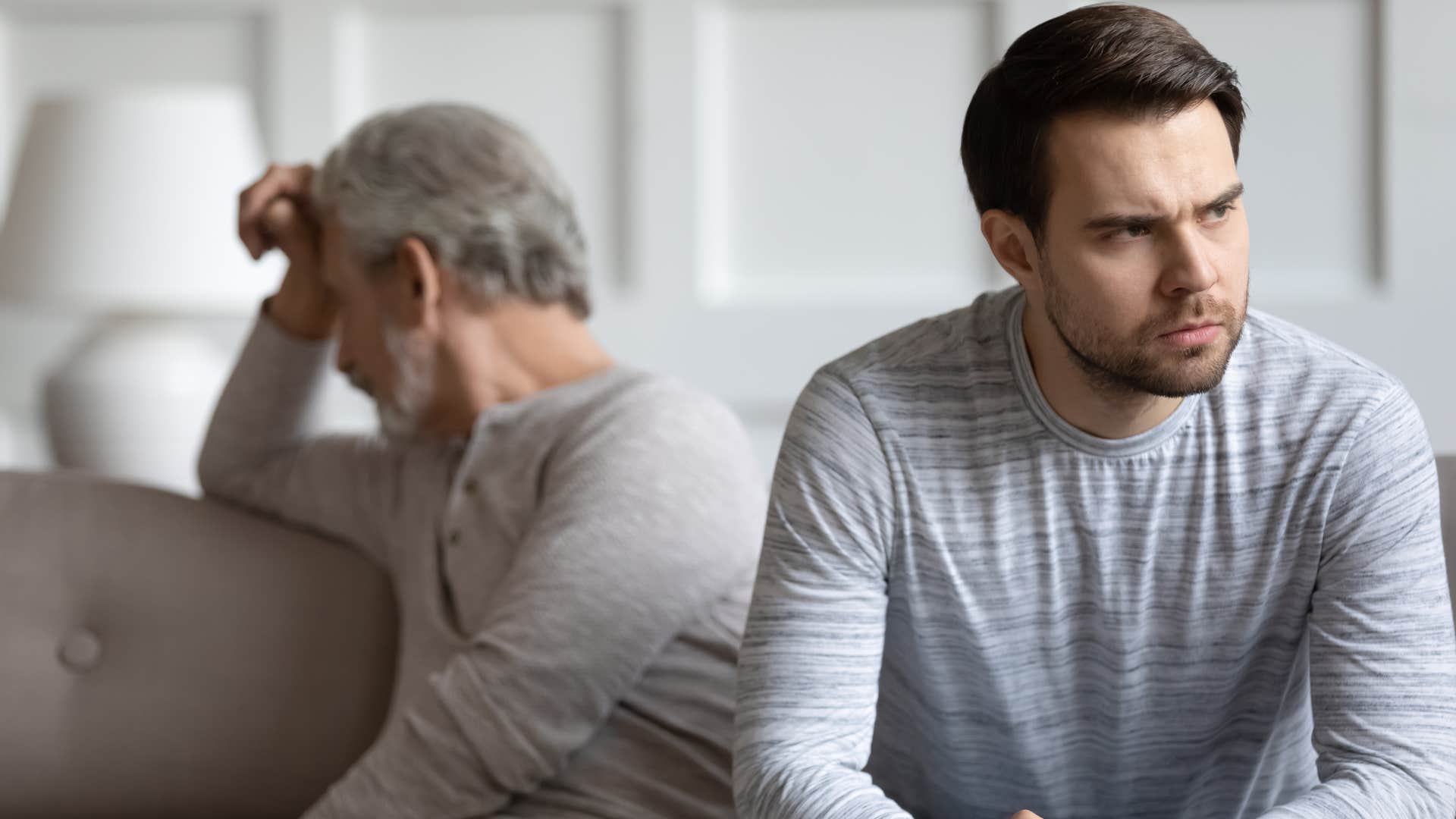 Man saying "Can't you see I'm struggling?" to his upset father.