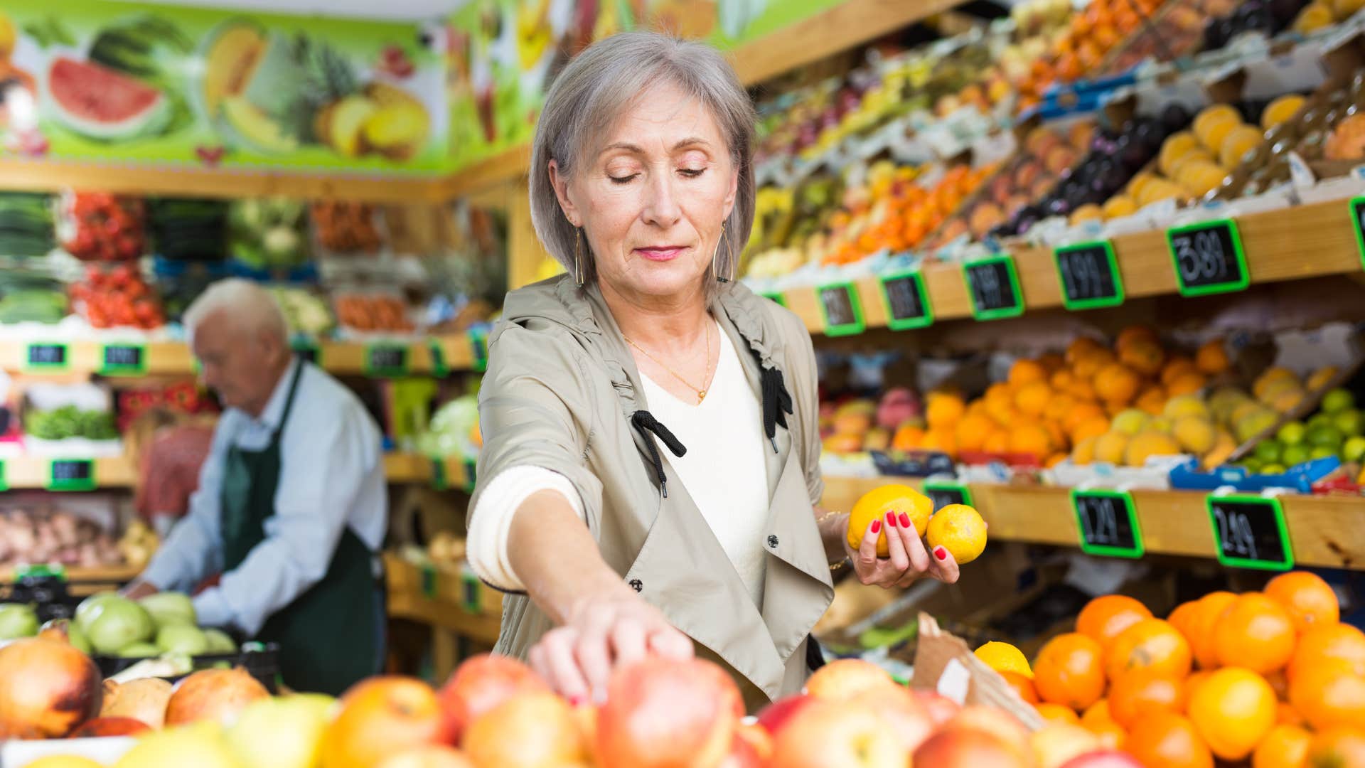older southern lady making groceries as she picks up apples