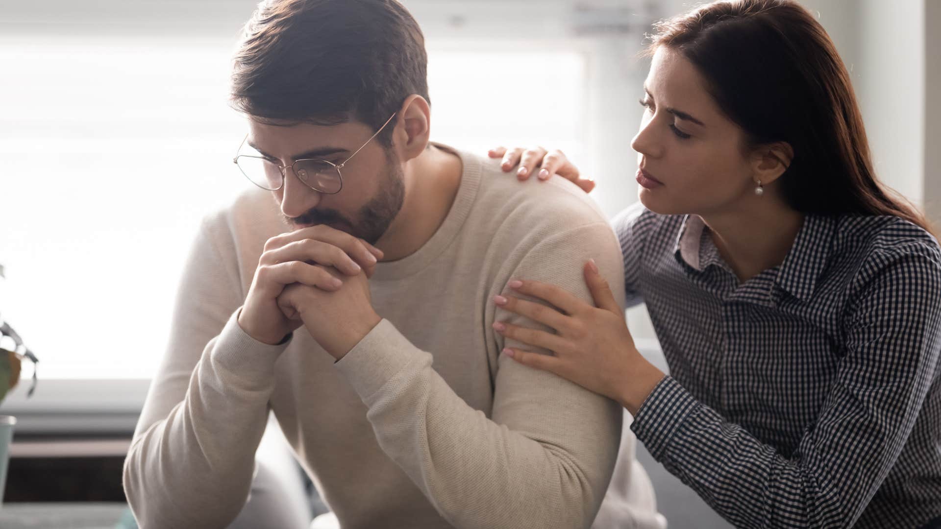 upset man saying i knew this would happen to me while wife comforts him