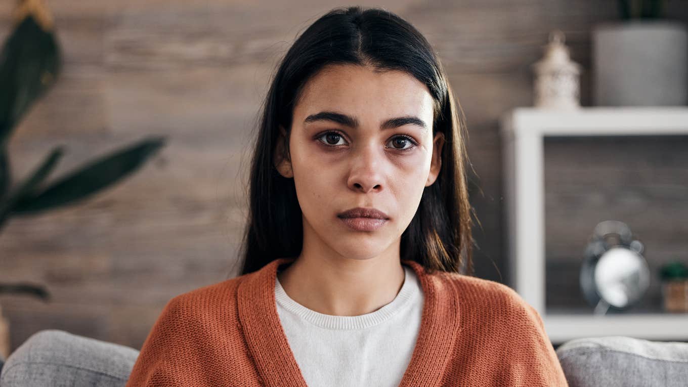Phrases That Instantly Reveal You Were Raised In A Controlling Household, According To Psychology sad anxious woman thinking about her controlling childhood