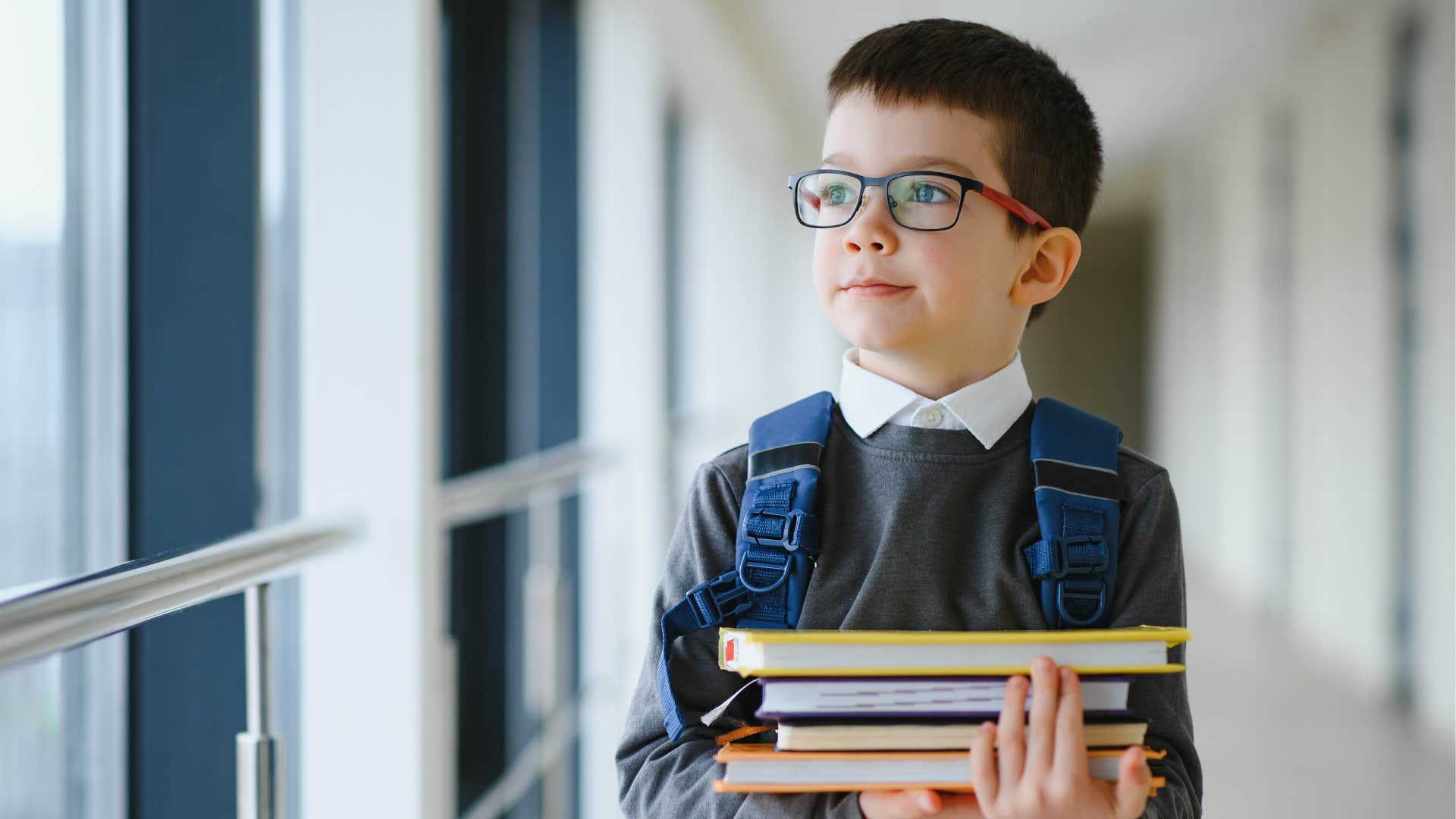 young boy walking in school hall