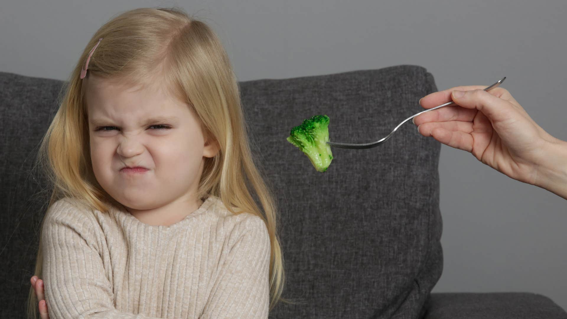 mom trying to feed picky daughter food