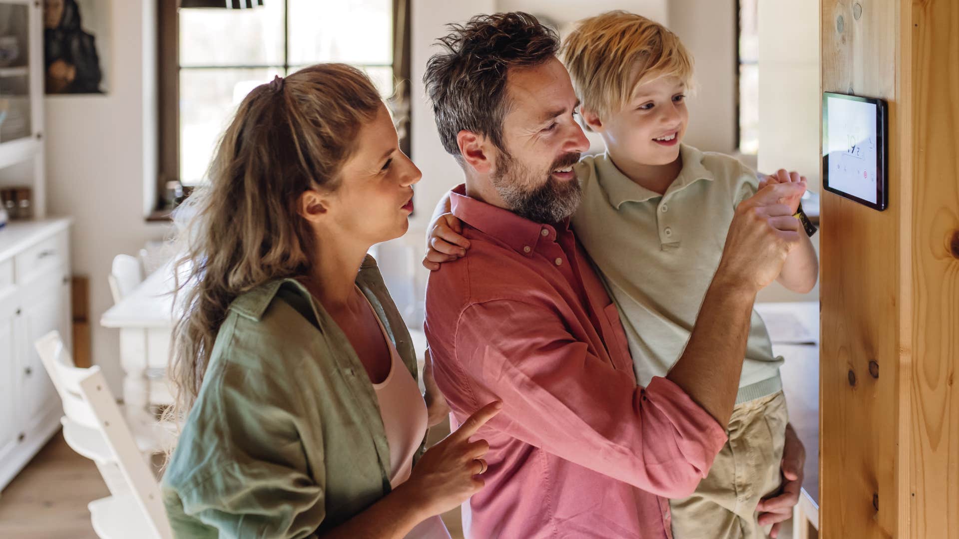father teaching son to never touch the thermostat