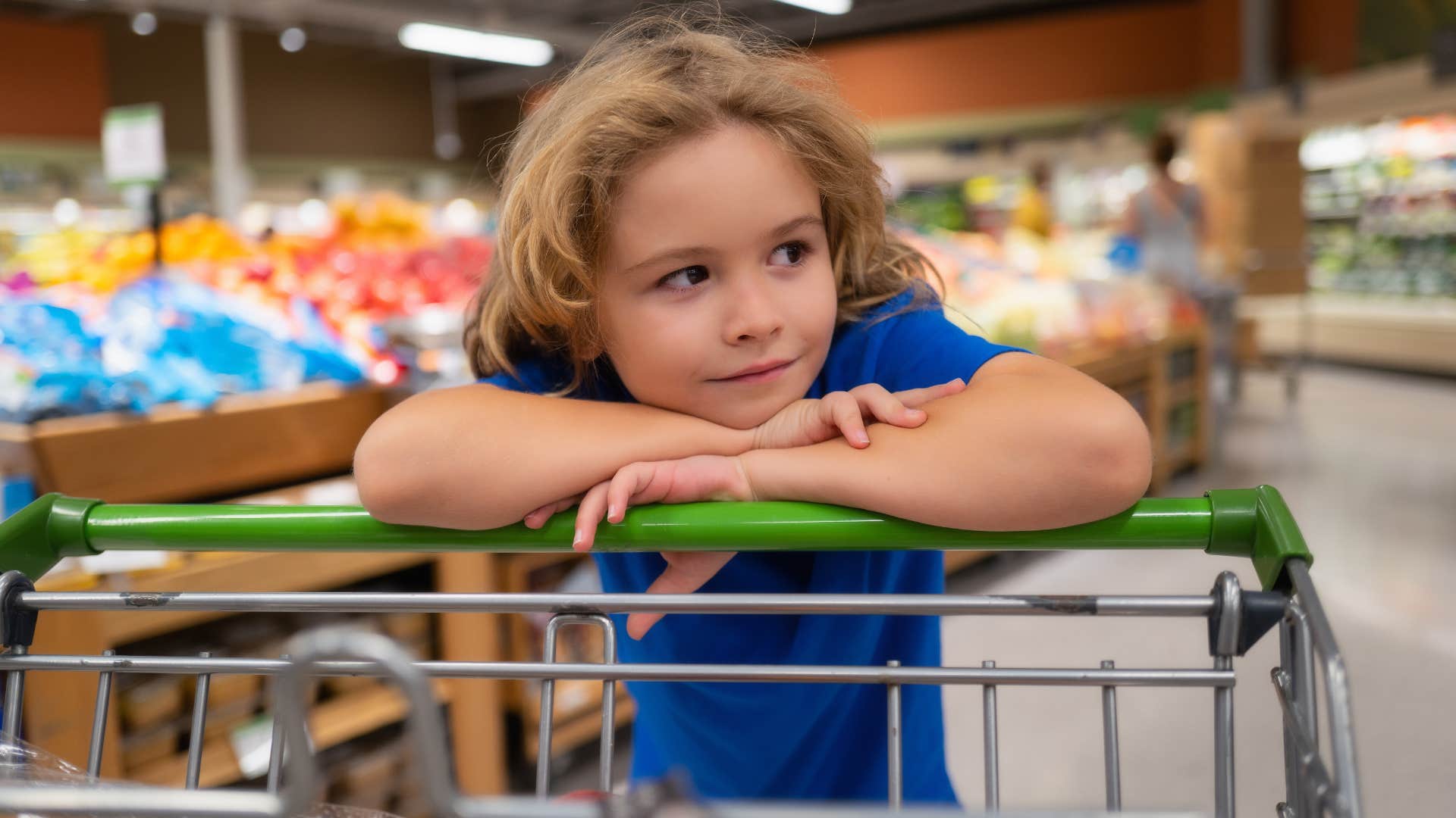 little boy looking at brand name items at grocery store