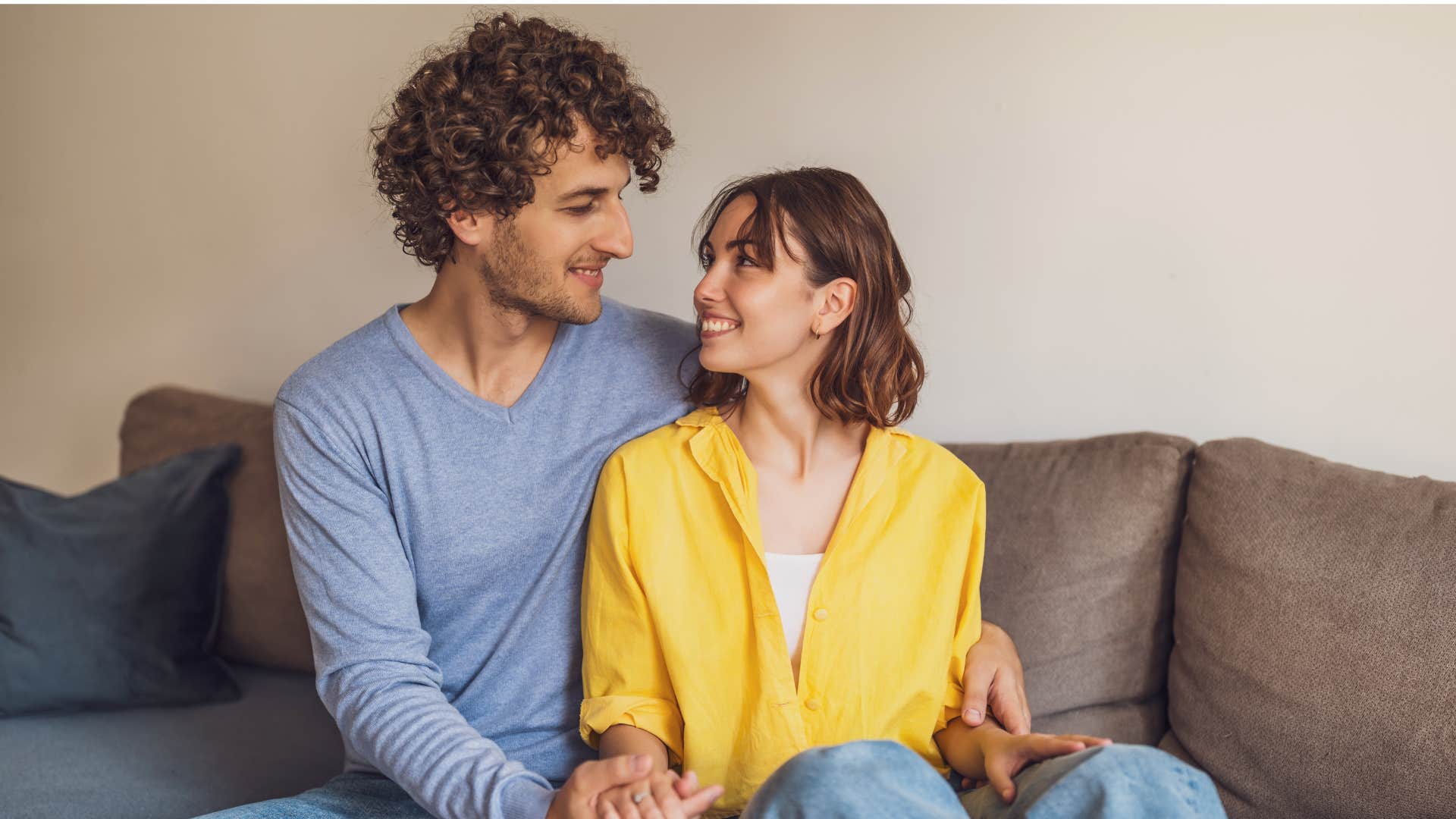 woman sitting next to man smiling at each other