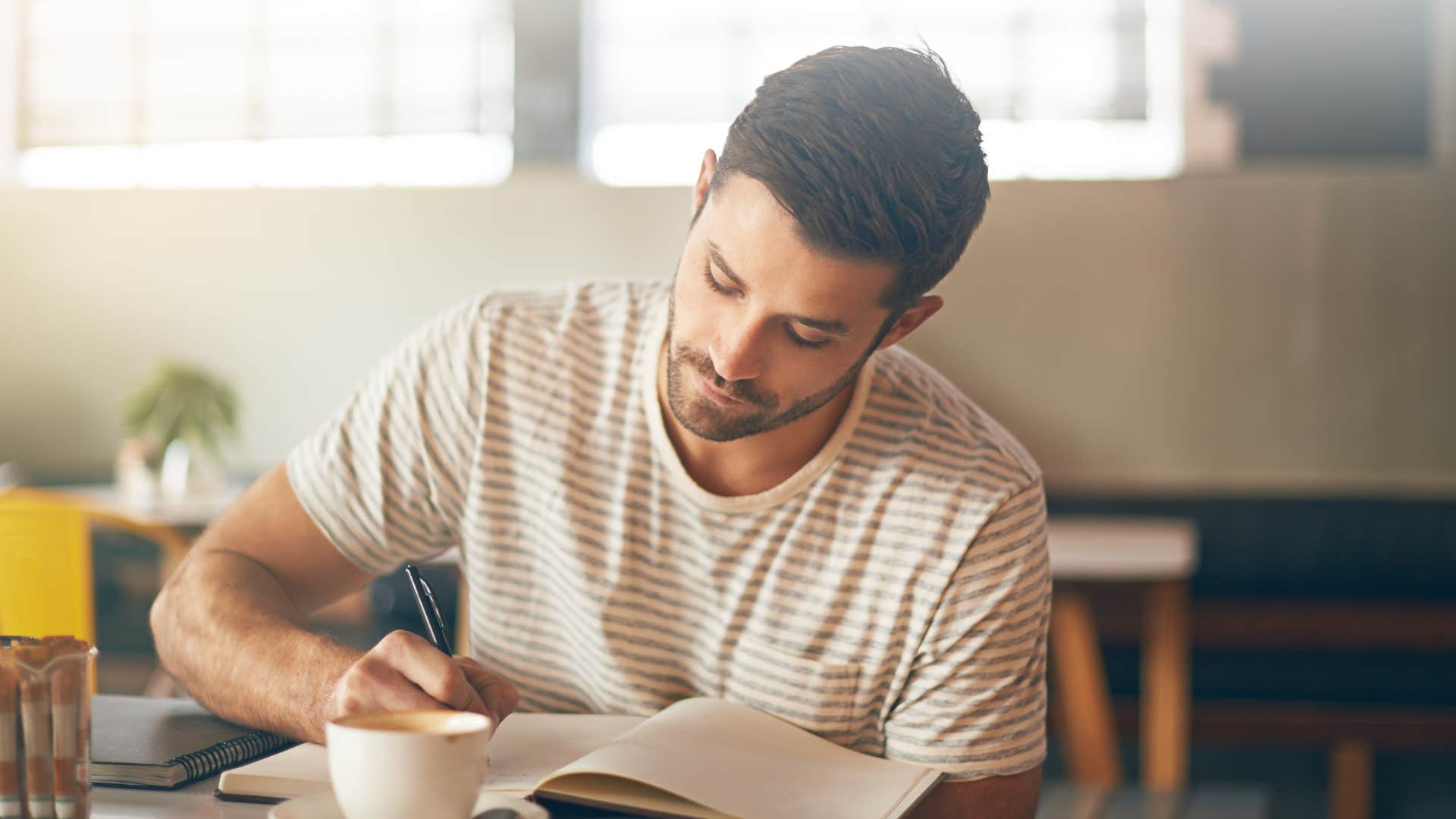man managing anger by writing in journal