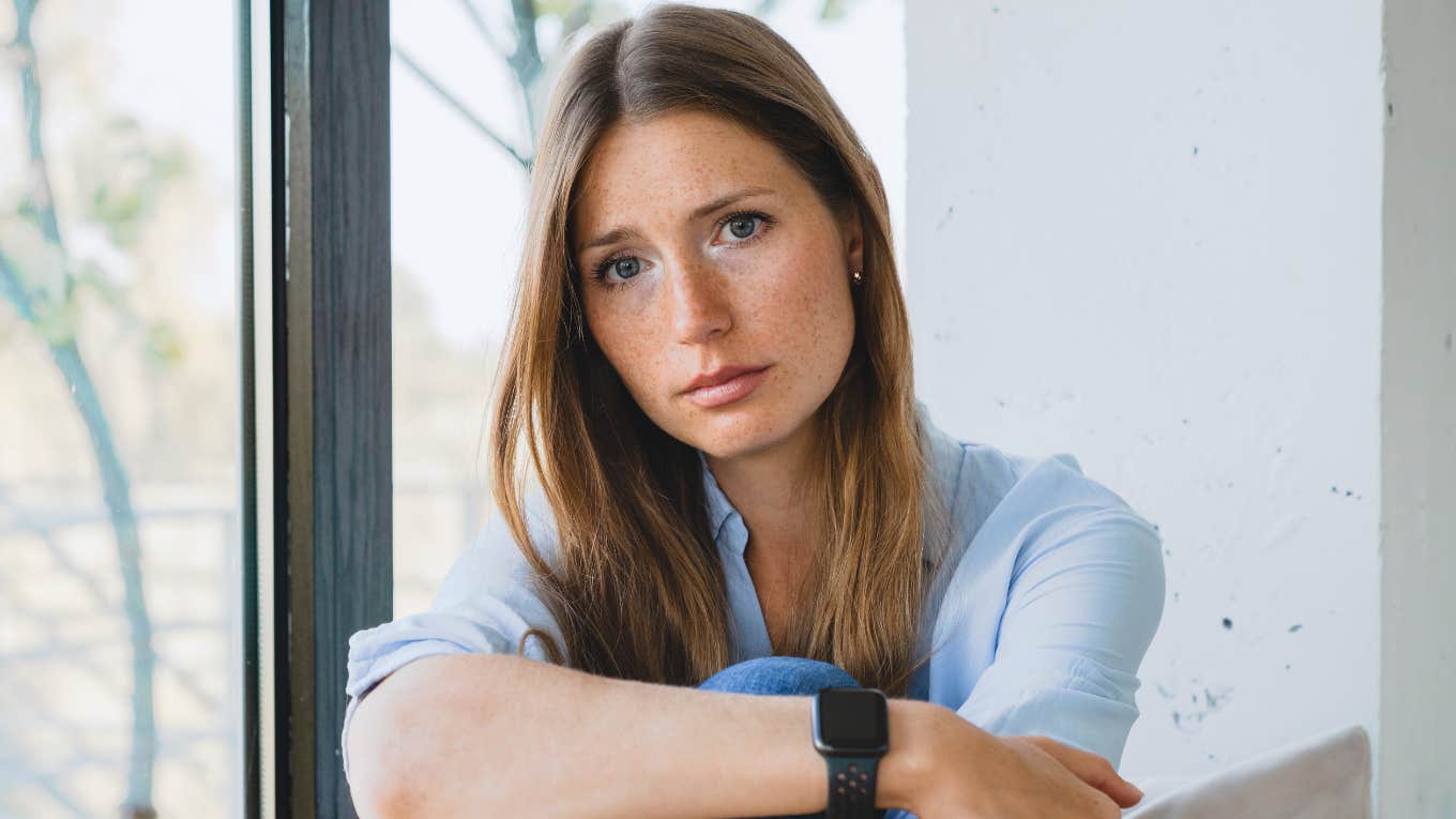 Quiet Clues Someone Wasn't Raised With Financial Stability, According To Psychology sad pensive woman who was raised without financial stability