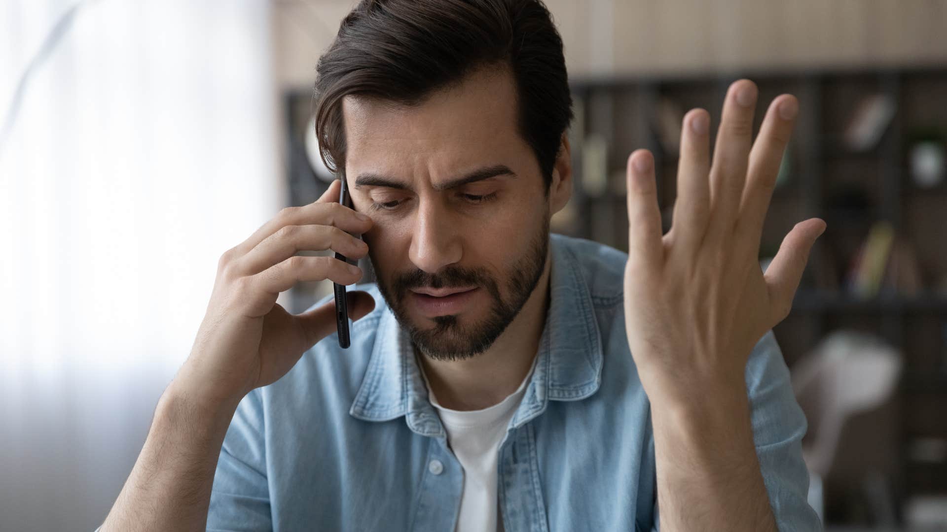 man talking on the phone refusing to ask for help
