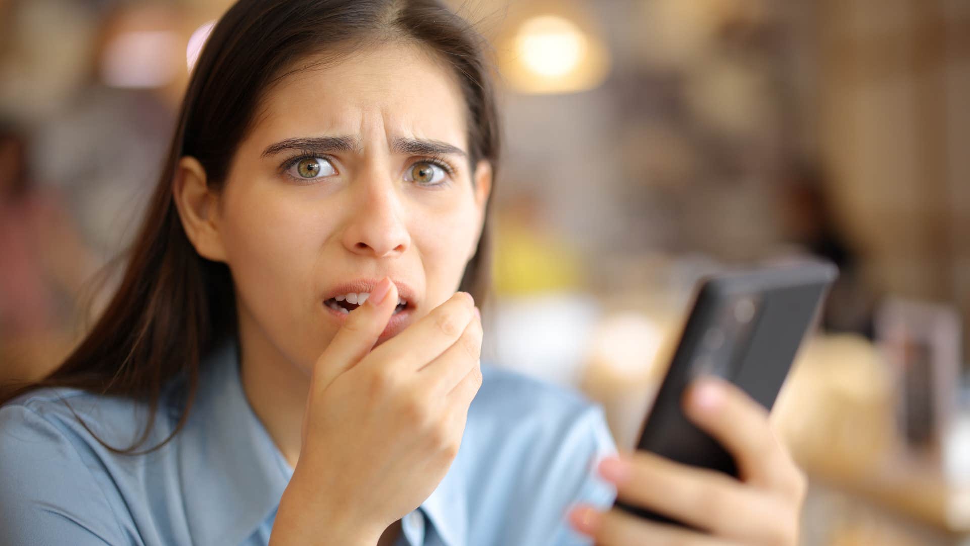 shocked woman looking at prices on her phone
