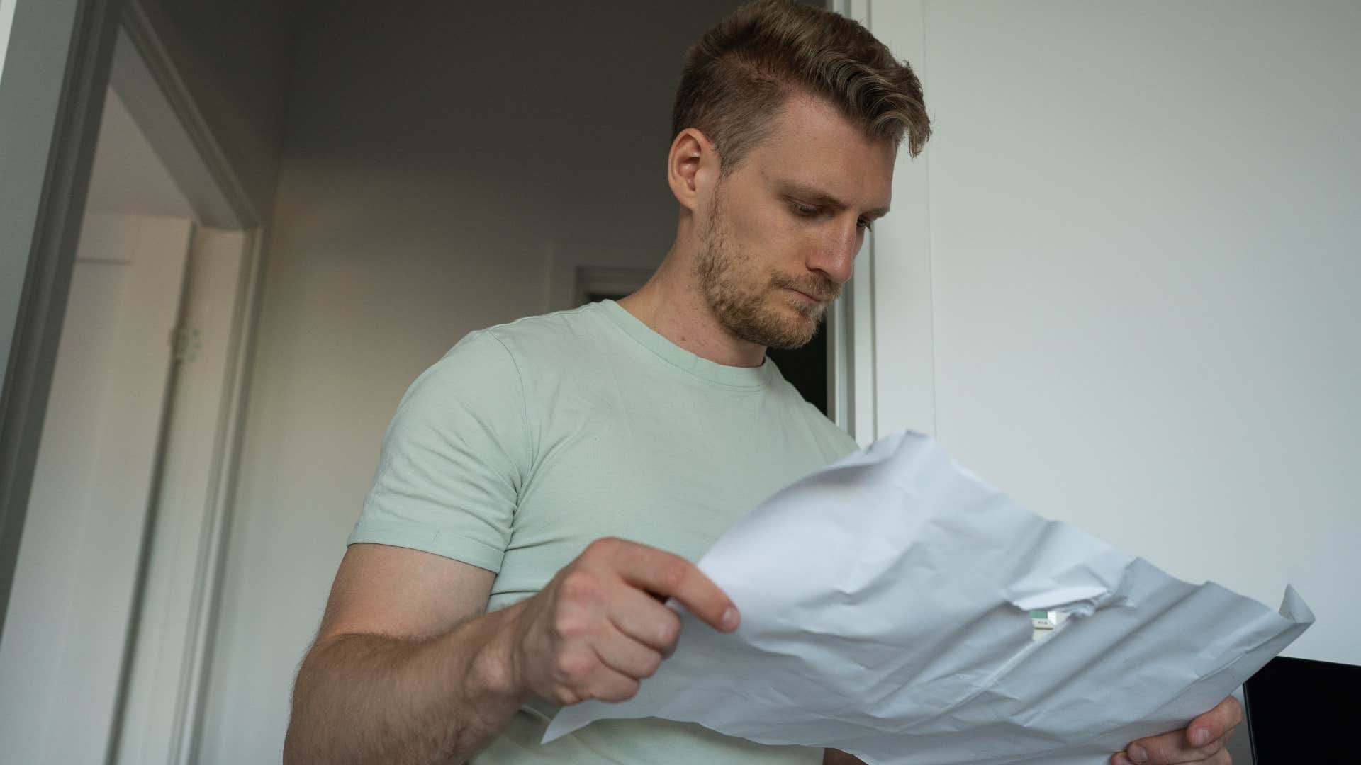 resourceful man looking at a bill