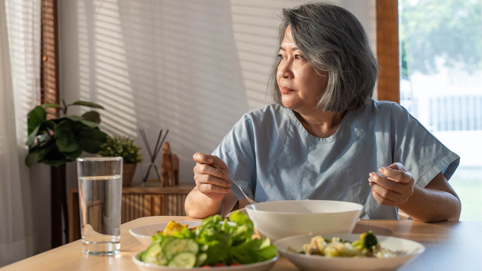 woman who refuses to waste food eating at a table