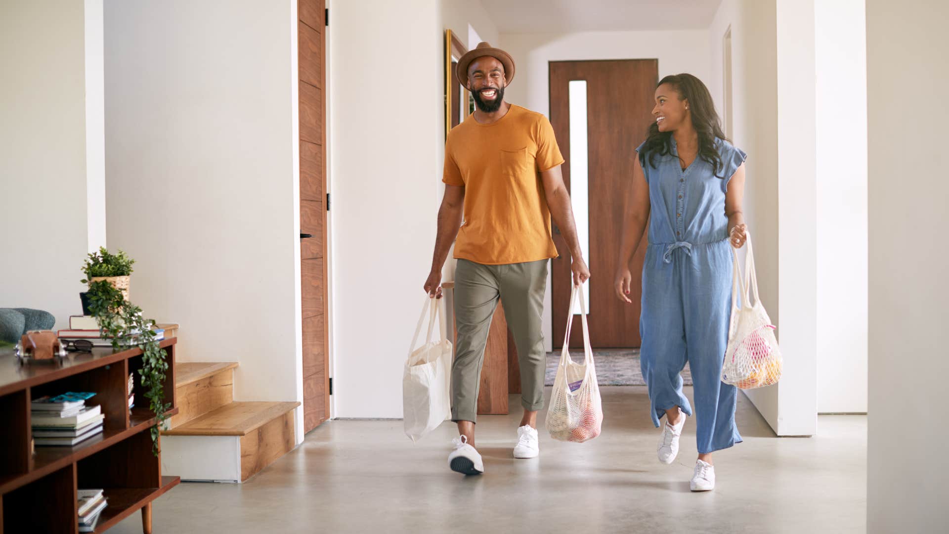 man carrying heavier grocery bags inside