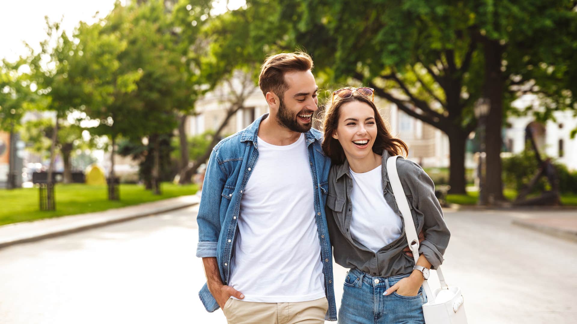 man walking with his wife on the traffic side of the street