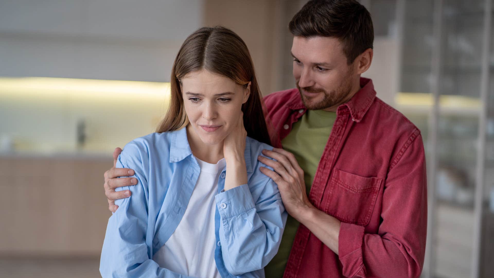 Man who is hyperaware of your body language hugging his wife.