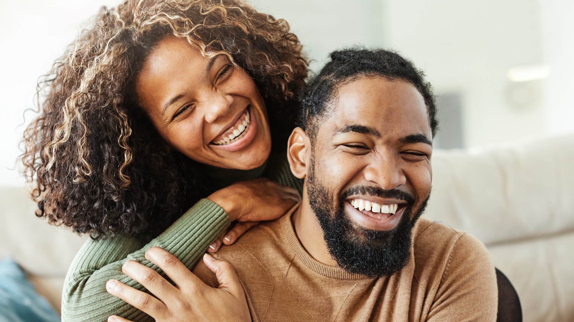 Man who respects your boundaries smiling and hugging his wife.