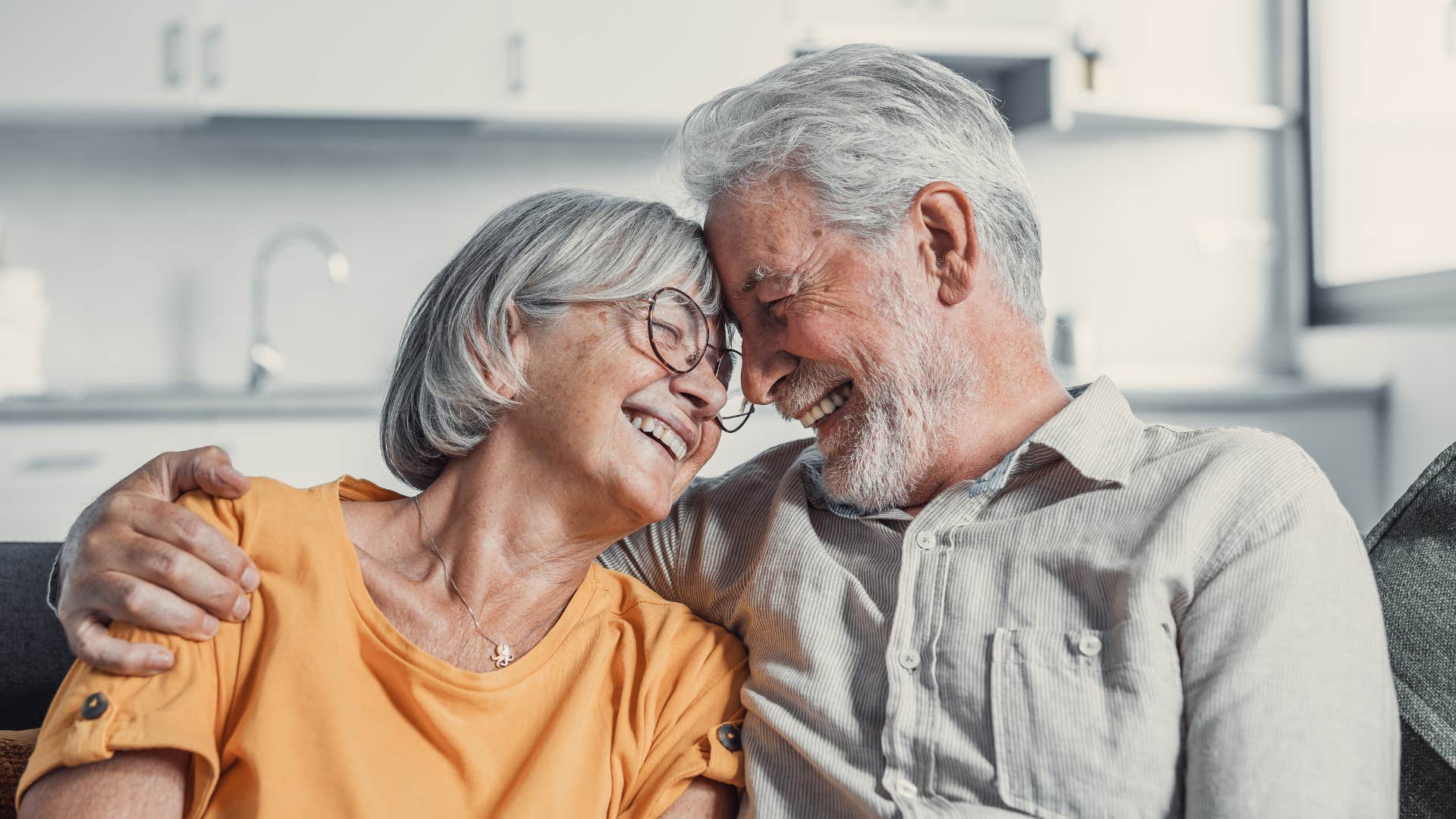 Man who takes care of himself smiling and hugging his wife.