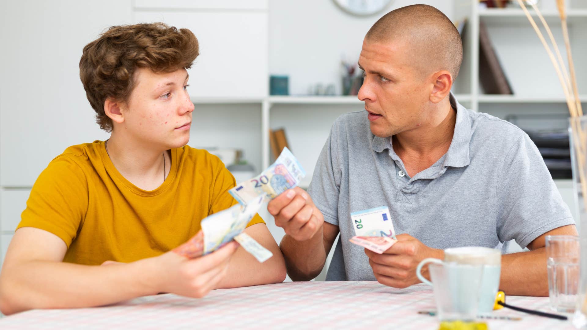 a father gives his son money to show that he loves him