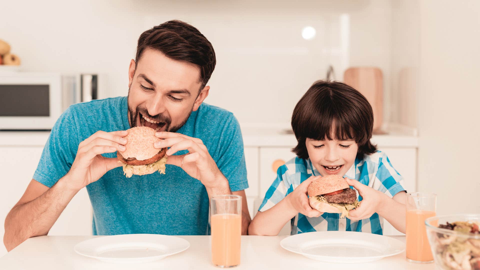 a dad makes sure his son eats
