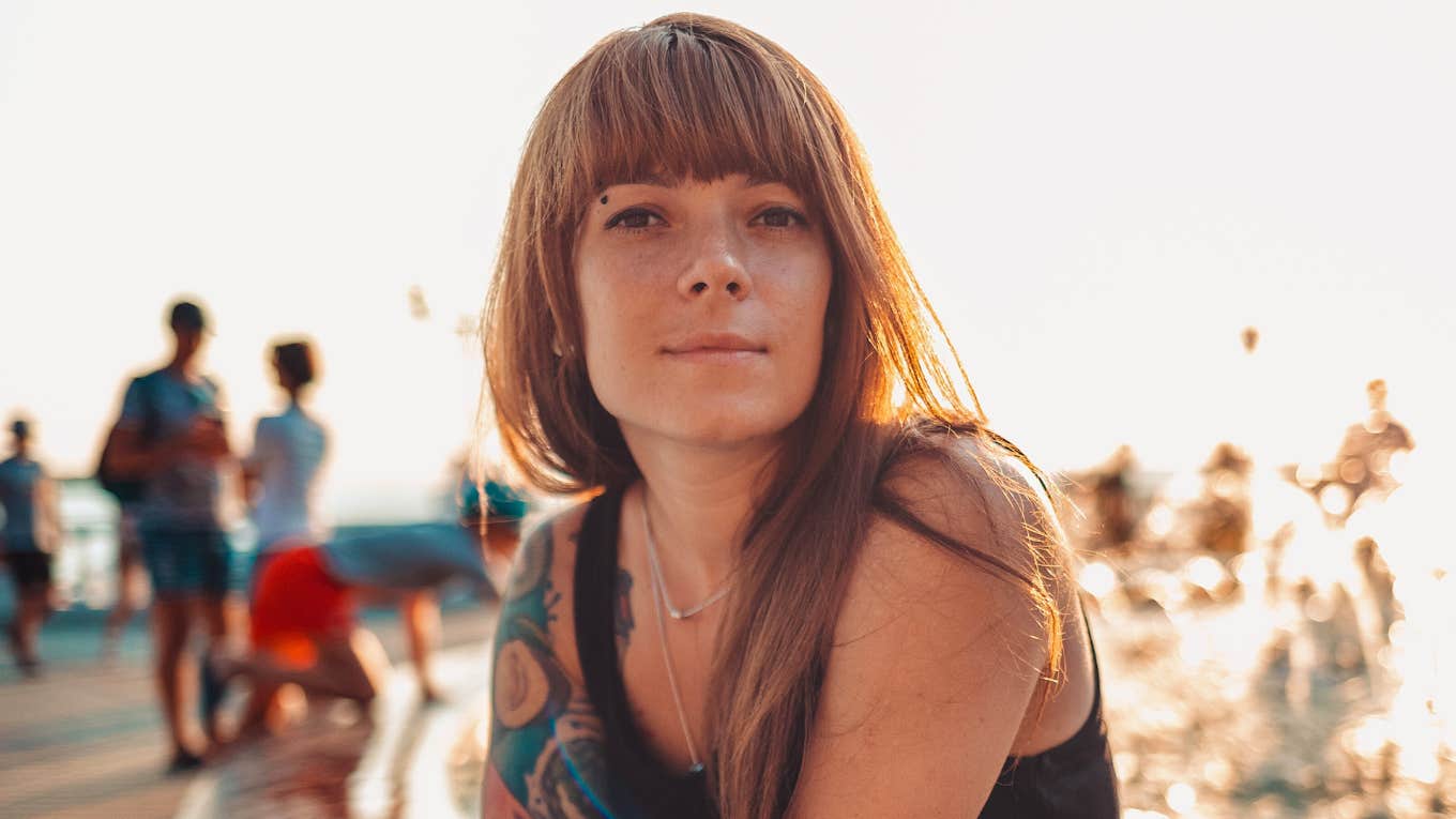 Rare Behaviors Of Truly Genuine People genuine woman smiling by the water