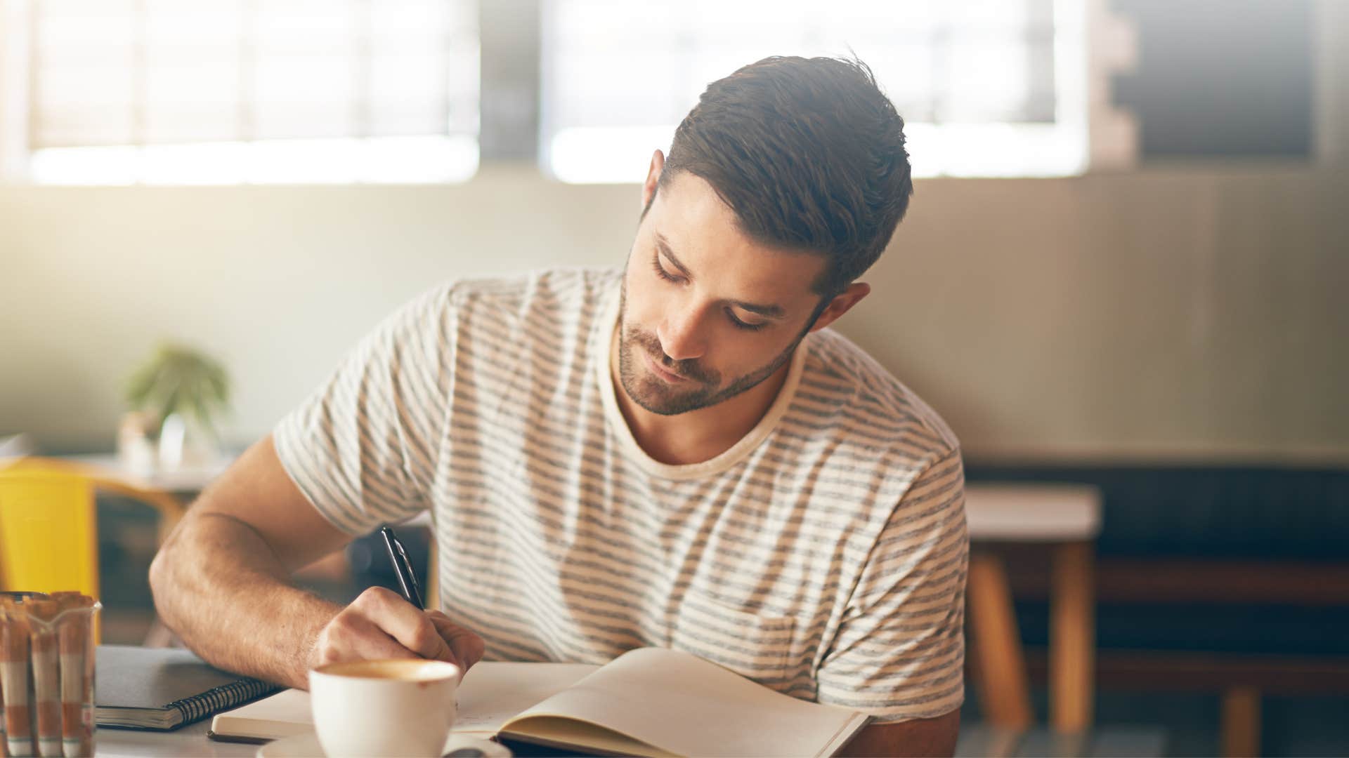 man who is resilient writing in gratitude journal