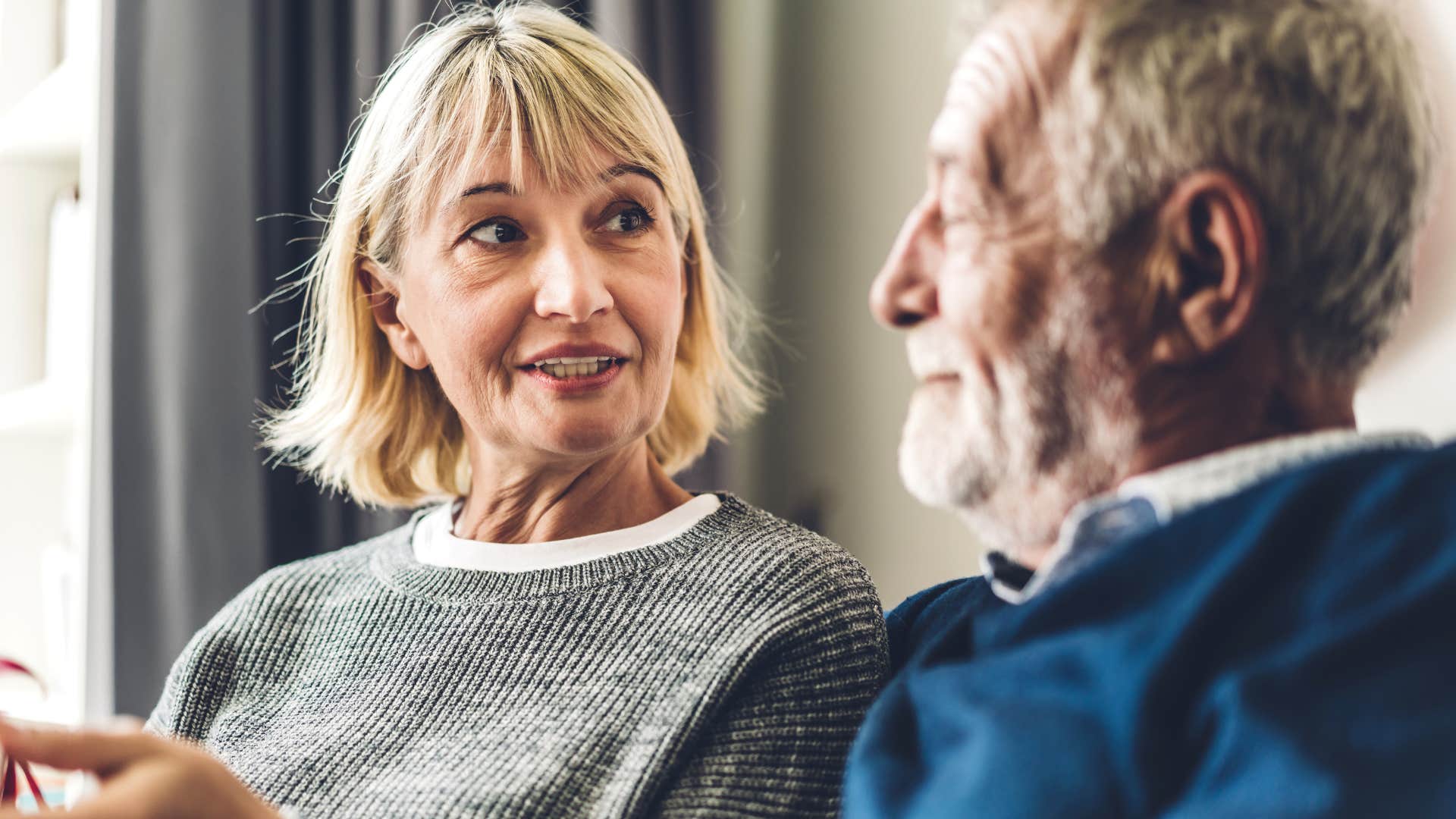 Man who's comfortable in arguments smiling at his wife.