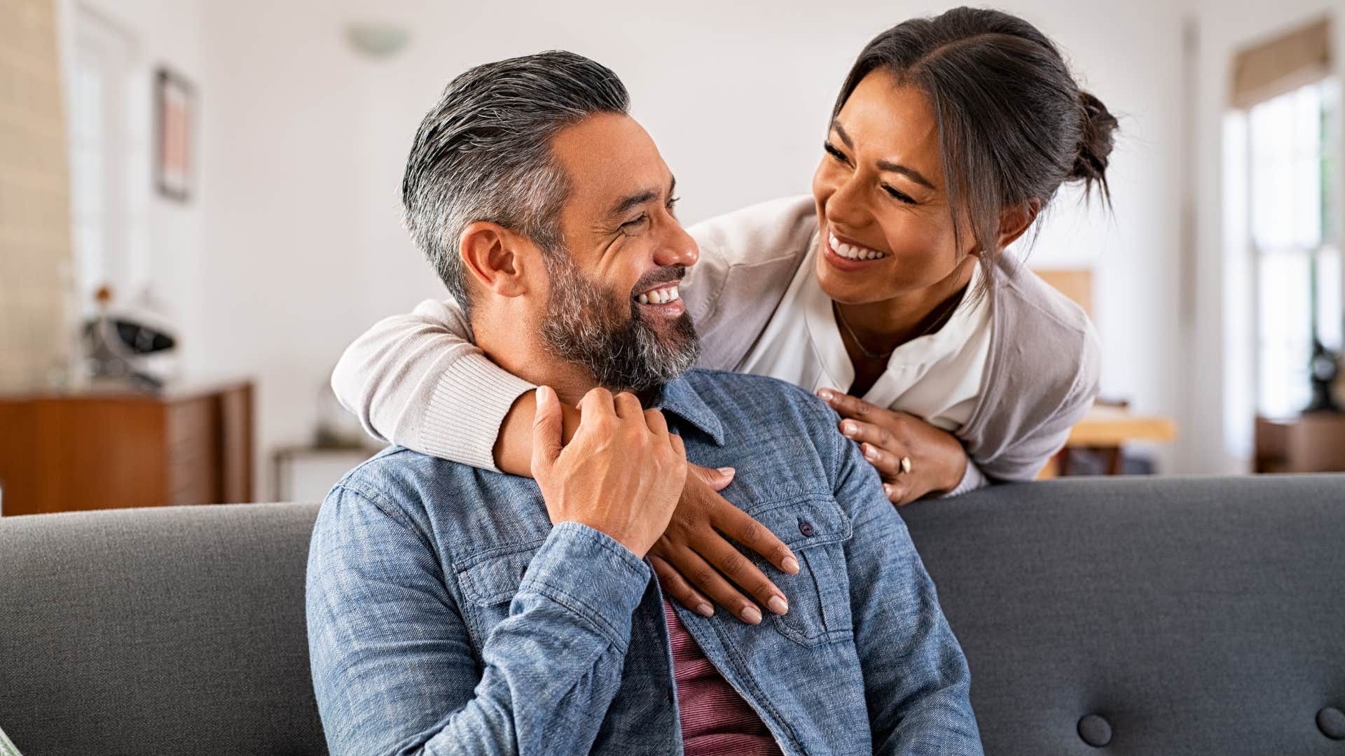 Man who doesn't try to fix you smiling and looking at his wife.