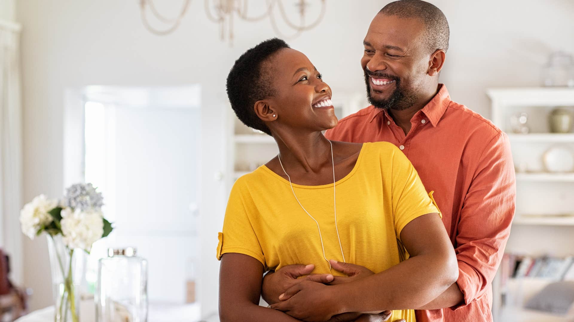 Man who doesn't have unrealistic expectations smiling at his wife.