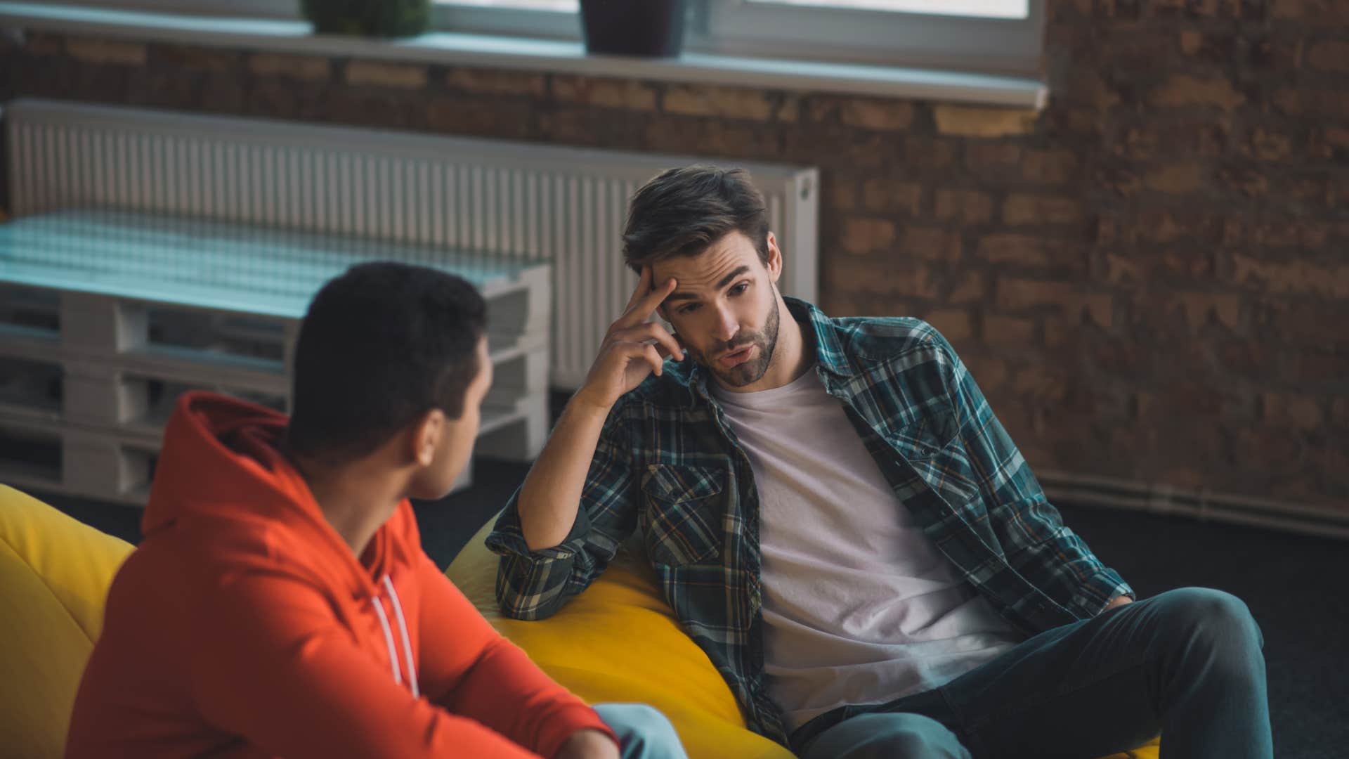 man defending his partner to his friend during conversation