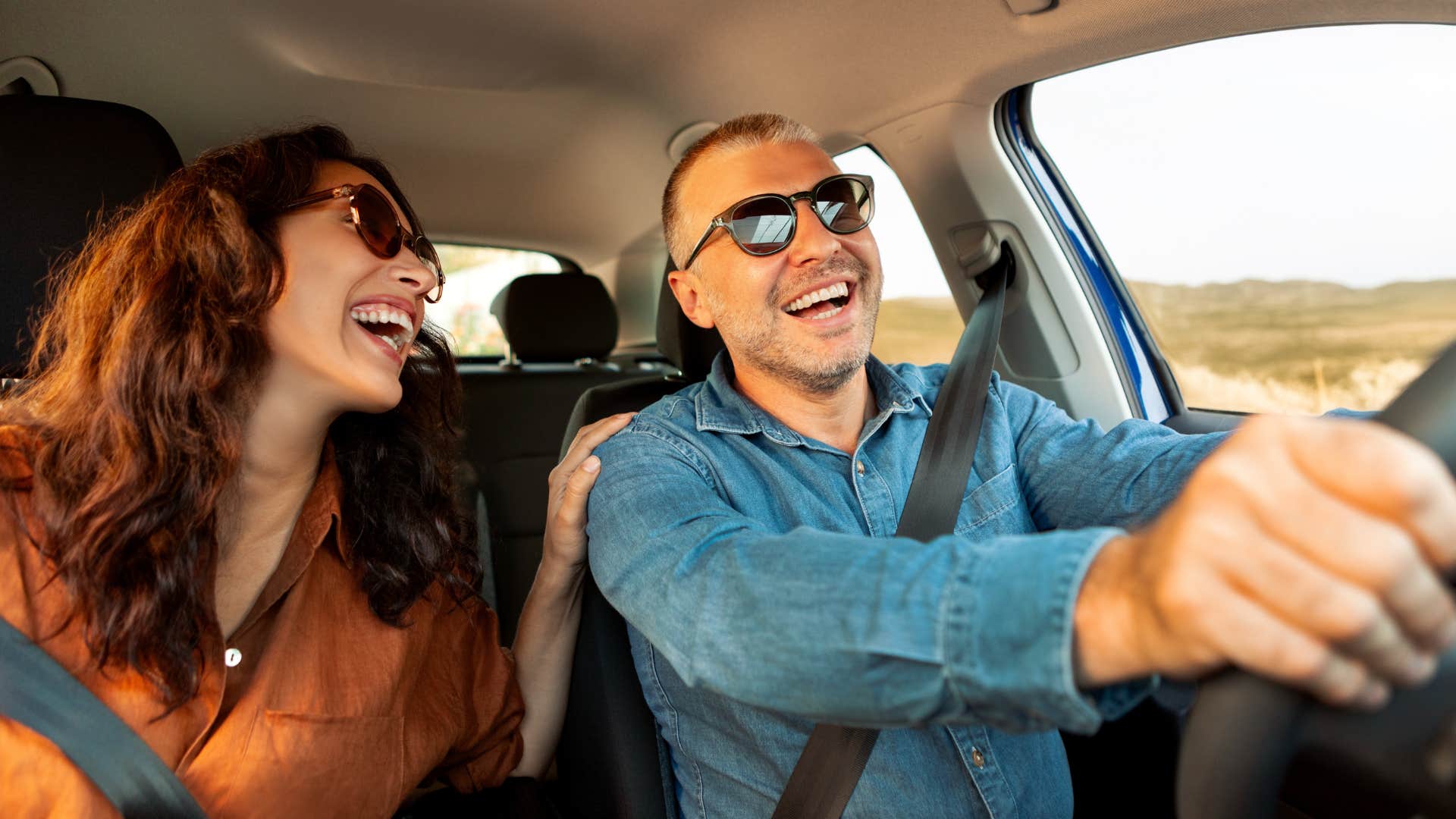 couple laughing and being silly together in a car
