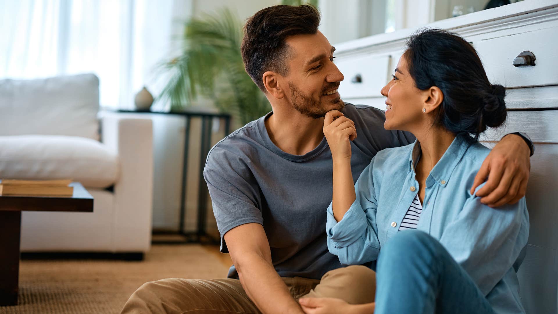 couple talking and cuddling on the floor
