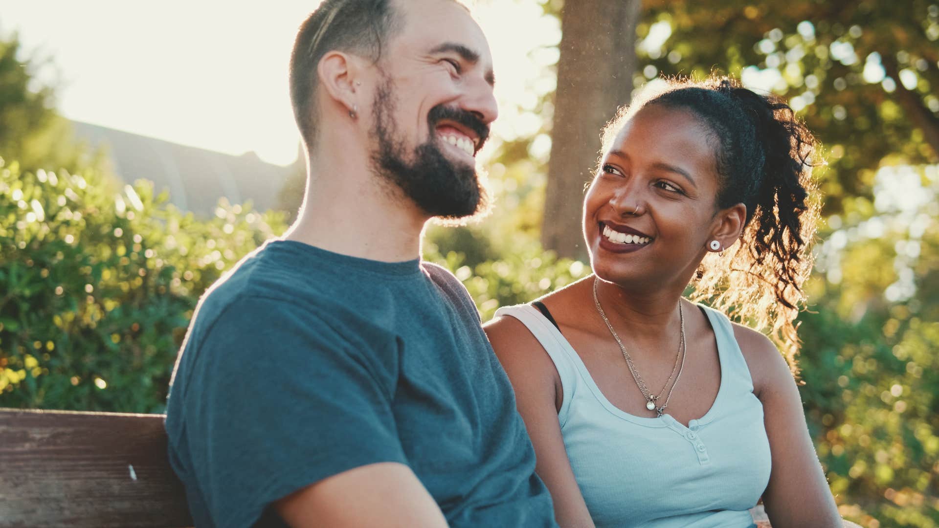 man opening up to partner on park bench