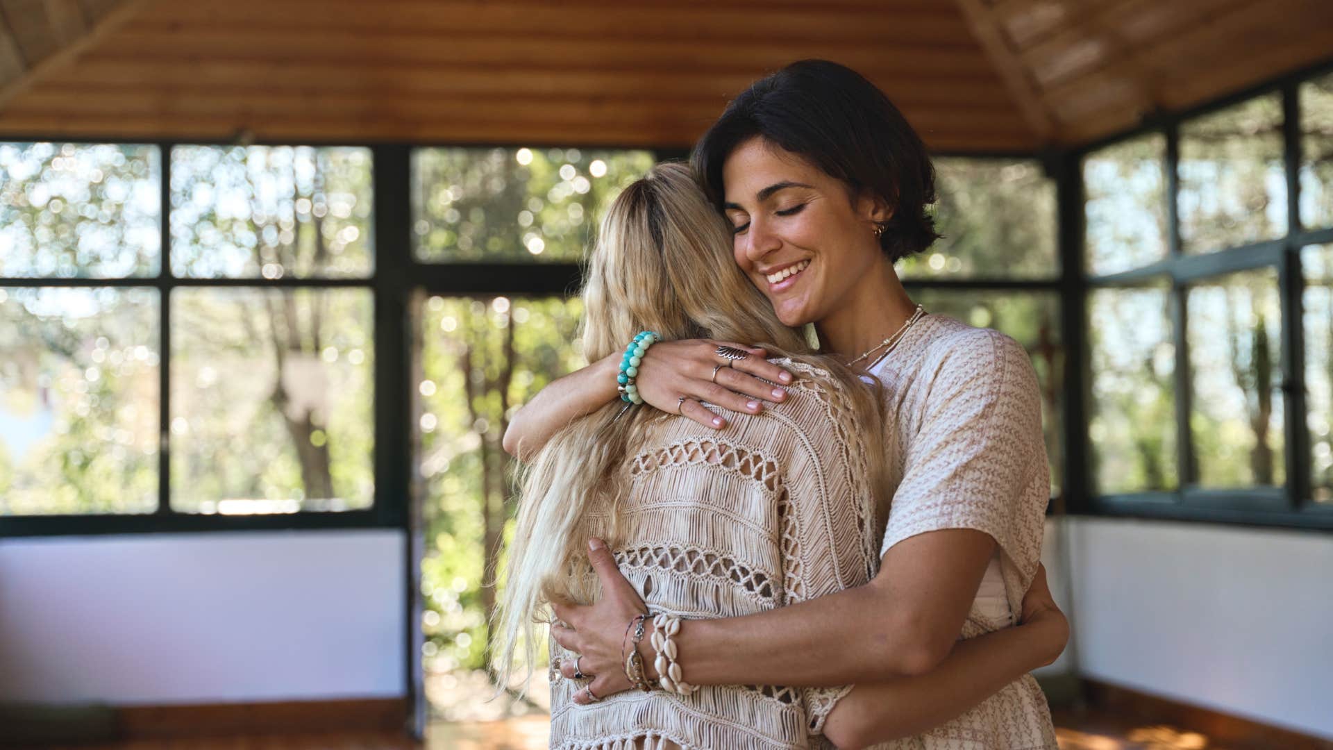 humble woman hugging friend keeping her calm