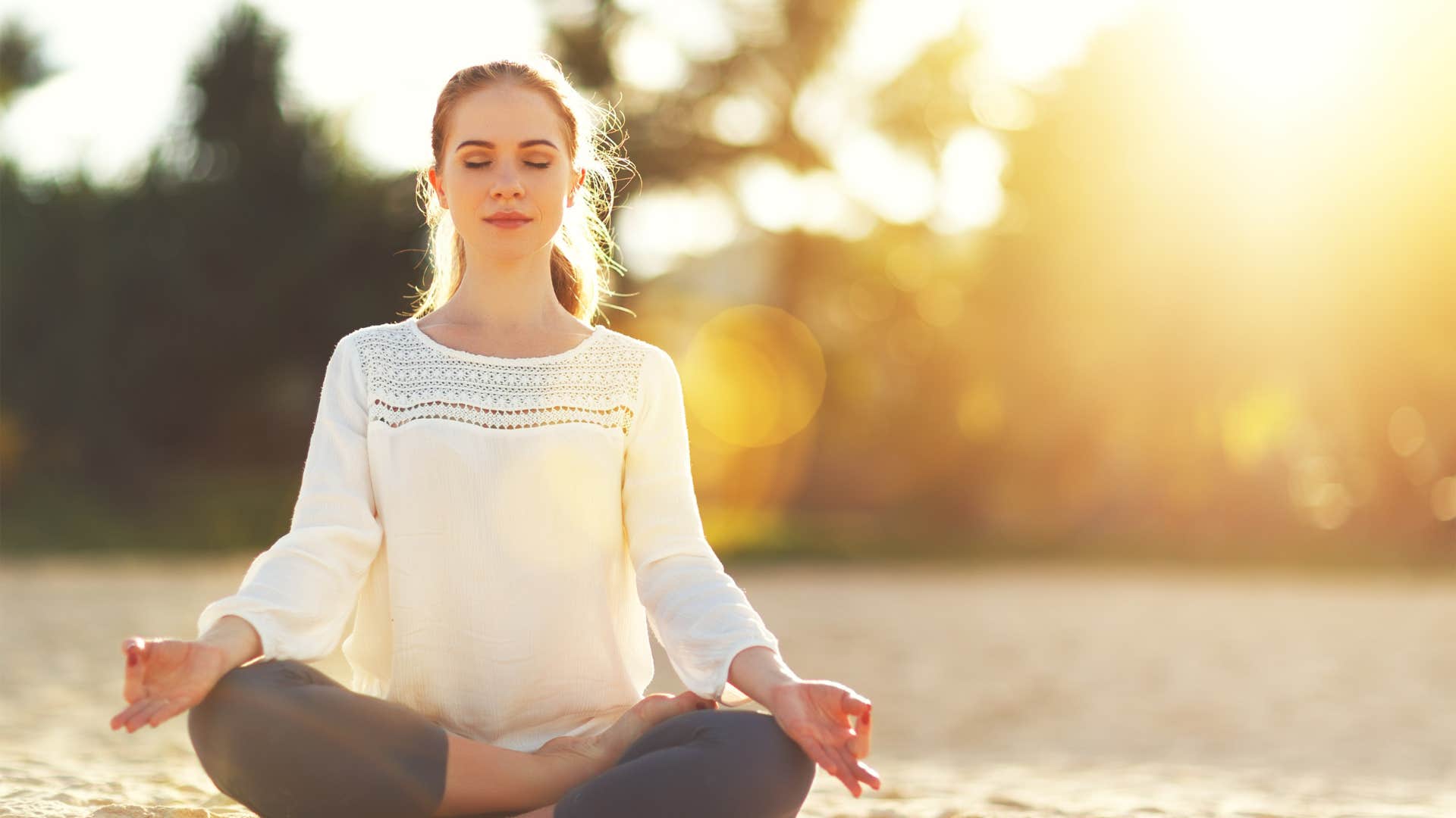 non-materialistic woman meditating peacefully outside